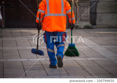 Closeup of legs of man cleaning the street Closeup of legs of man cleaning the street 100799650