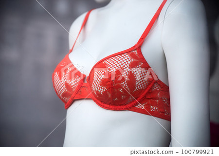 Closeup of orange bra on mannequin in a fashion store showroom Closeup of orange bra on mannequin in a fashion store showroom 100799921