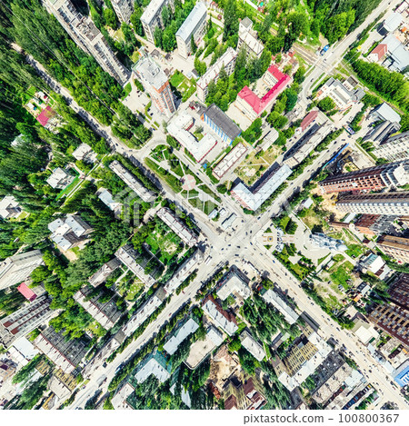 Aerial city view with crossroads and roads, houses, buildings, parks and parking lots. Sunny summer panoramic image Aerial city view with crossroads and roads, houses, buildings, parks and parking lots. Sunny summer panoramic image 100800367