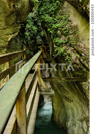 Vertical shot of a mossy wooden footbridge over the Seisenbergklamm gorge at Weissbach bei Lofer Vertical shot of a mossy wooden footbridge over the Seisenbergklamm gorge at Weissbach bei Lofer 100800443