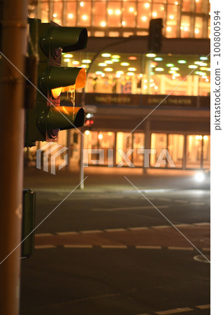 Vertical shot of a red traffic lights at night in Muenster, Germany Vertical shot of a red traffic lights at night in Muenster, Germany 100800594