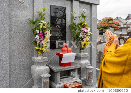 A monk recites in front of the Perpetual Memorial Cemetery A monk recites in front of the Perpetual Memorial Cemetery 100800650