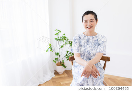A woman sitting with a smile 100804465