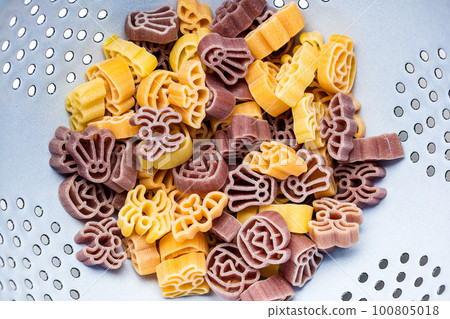 Pasta of various scary shapes. Uncooked halloween pasta in colander. Pasta of various scary shapes. Uncooked halloween pasta in colander. 100805018