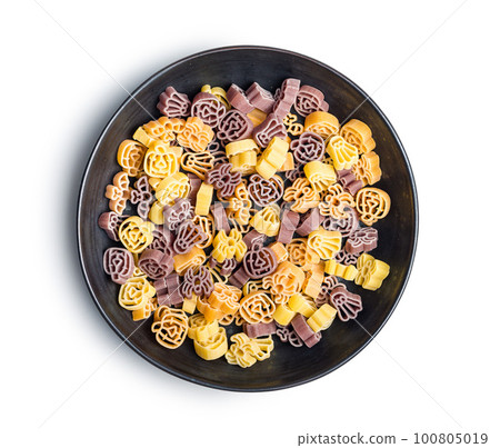 Pasta of various scary shapes. Uncooked halloween pasta in plate isolated on white background. Pasta of various scary shapes. Uncooked halloween pasta in plate isolated on white background. 100805019