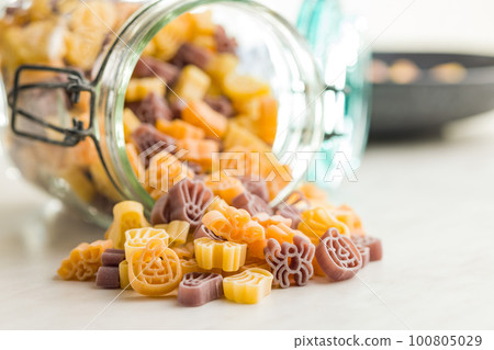 Pasta of various scary shapes. Uncooked halloween pasta on kitchen table. 100805029