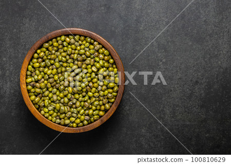 Top view of raw green mung beans in wooden bowl Top view of raw green mung beans in wooden bowl 100810629