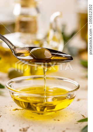 Green olive in spoon Green olive in spoon 100812302