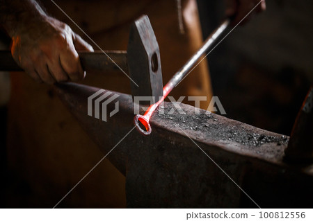 The blacksmith forge the hot metal 100812556