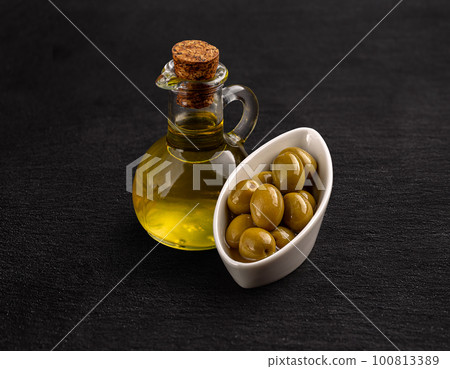 Olive oil and green olive seeds Olive oil and green olive seeds 100813389