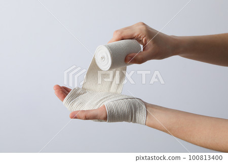 Concept of hand injury help with elastic bandage 100813400