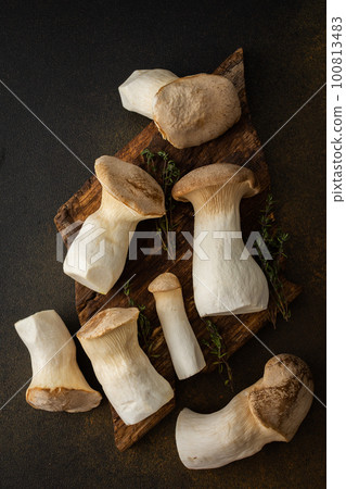 Eryngii mushrooms on a cutting board Eryngii mushrooms on a cutting board 100813483