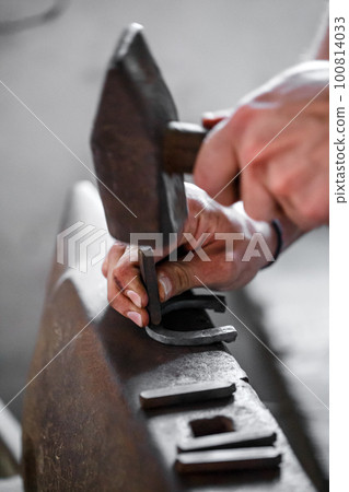 Hammering glowing steel. 100814033