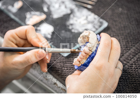 Dental technician working Dental technician working 100814050