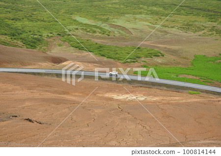 Aerial view of a car on a lonely road in a valley near the high-temperature area in Hverir, Iceland Aerial view of a car on a lonely road in a valley near the high-temperature area in Hverir, Iceland 100814144