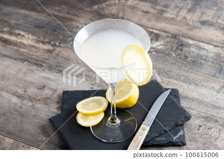 Lemon drop martini cocktail on gray stone and black background Lemon drop martini cocktail on gray stone and black background 100815006