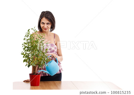 Young woman watering Young woman watering 100815235