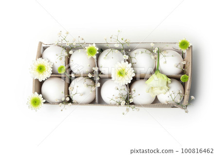 Egg box with eggs and flowers isolated on white background Egg box with eggs and flowers isolated on white background 100816462