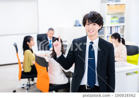 Businessman pointing finger in the office 100816562