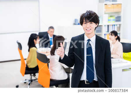 Young businessman giving a good sign with a smile 100817384