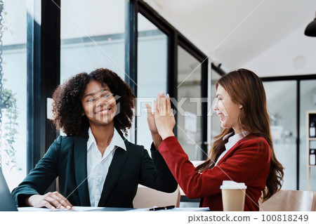 Multiethnic business, Beautiful American African and asian businesswoman people meeting Diverse Happy people celebrating success at company, teamwork, triumph, victory, achievement concept. 100818249