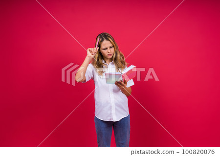 Child making notes. Kids dreams.Isolated on red background. Education, Kid back to school. 100820076