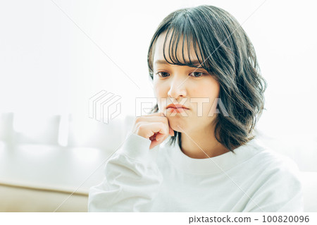 Young woman thinking in the room Young woman thinking in the room 100820096