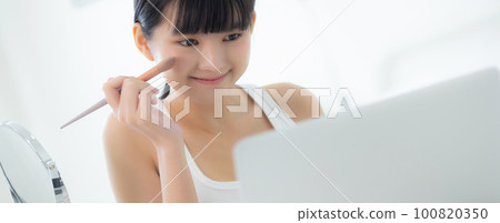 Beauty of young asian woman with learning makeup with brush on cheek on laptop. Beauty of young asian woman with learning makeup with brush on cheek on laptop. 100820350