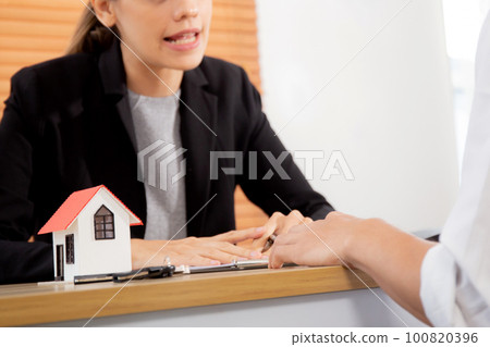 Young man customer talking with agent about contract buying house and agreement. Young man customer talking with agent about contract buying house and agreement. 100820396