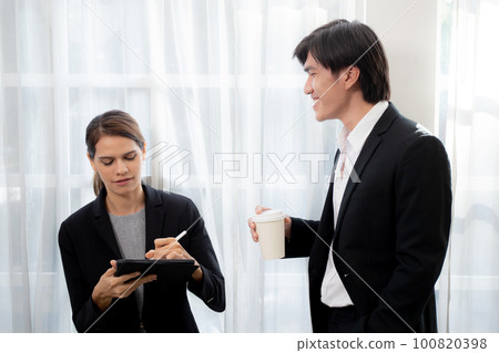 Young manager talking with secretary about report marketing on digital tablet. Young manager talking with secretary about report marketing on digital tablet. 100820398