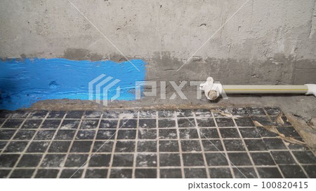 Waterproofing the floor before leveling. Primer for concrete floor before finishing. Repair in the house. Copy space 100820415
