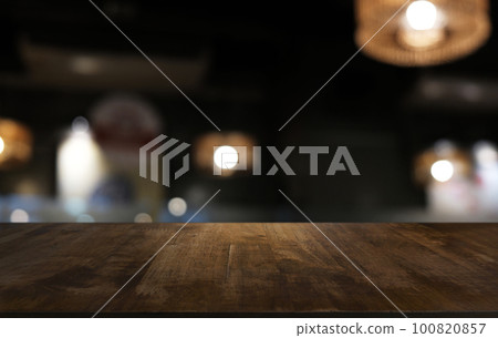 Empty dark wooden table in front of abstract blurred bokeh background of restaurant . can be used for display or montage your products.Mock up for space. Empty dark wooden table in front of abstract blurred bokeh background of restaurant . can be used for display or montage your products.Mock up for space. 100820857