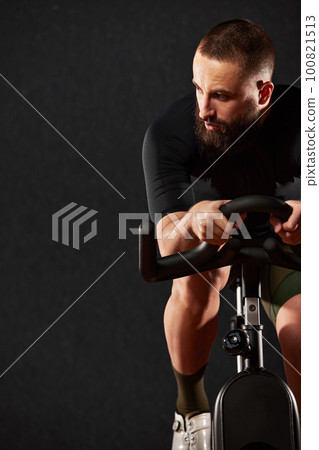 Portrait of a cyclist with a beard on a dark background Portrait of a cyclist with a beard on a dark background 100821513