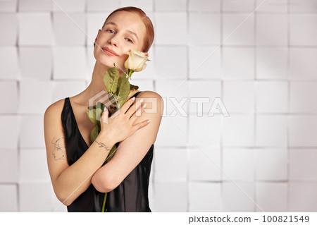 Beautiful young with special needs woman with flowers in her hand holding a flower, woman in black dress. Diversity women with disability and flowers. Beautiful young with special needs woman with flowers in her hand holding a flower, woman in black dress. Diversity women with disability and flowers. 100821549