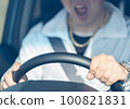 Middle-aged male driver's hand holding the steering wheel while screaming 100821831