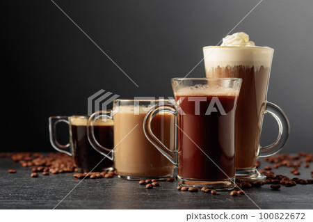 Various coffee and chocolate drinks on a black table. 100822672