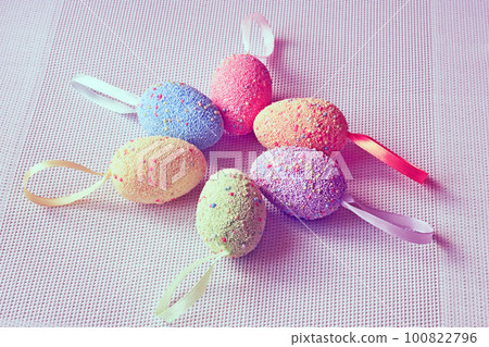 Multi colored Easter eggs on a woven fabric in pink 100822796