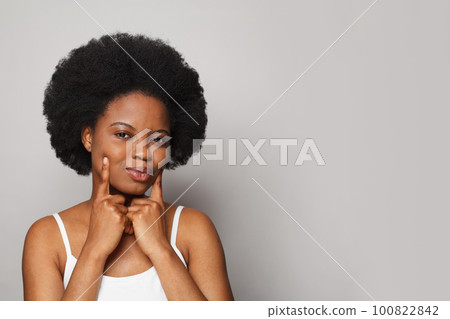 Attractive cheerful lovely pretty funny woman smiling and touching her hands her cheeks 100822842