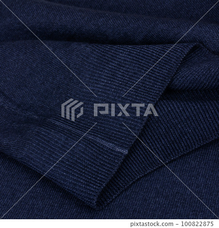 Knitted elastic band on navy blue wool jumper close up Knitted elastic band on navy blue wool jumper close up 100822875
