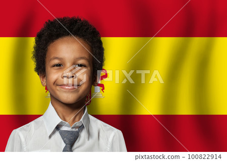 Spanish kid boy on flag of Spain background. Education and childhood concept 100822914