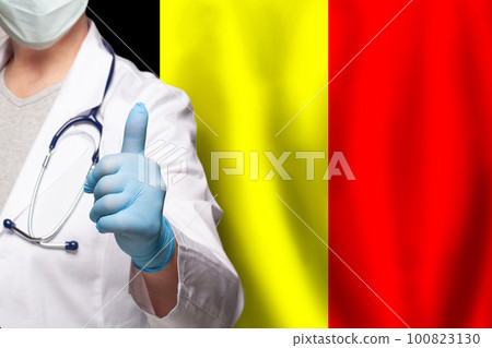 Belgian doctor's hand showing thumb up positive gesture on flag of Belgium background Belgian doctor's hand showing thumb up positive gesture on flag of Belgium background 100823130