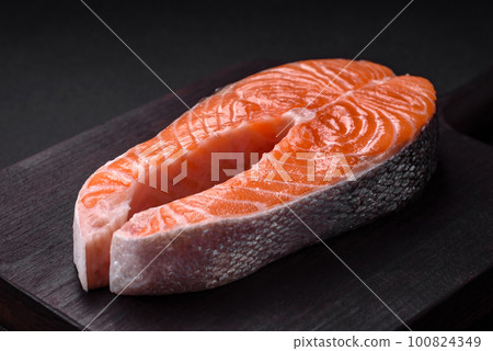 Fresh raw red fish steak with spices and herbs Fresh raw red fish steak with spices and herbs 100824349
