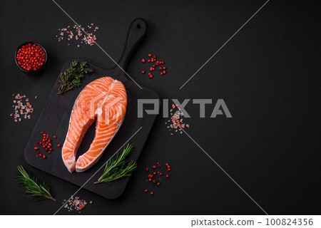 Fresh raw red fish steak with spices and herbs Fresh raw red fish steak with spices and herbs 100824356