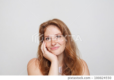 Portrait of pretty young woman with friendly smile on white background 100824550