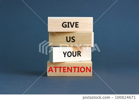Give us your attention symbol. Concept words Give us your attention on wooden block. Beautiful grey table grey background. Motivational business give us your attention concept. Copy space. 100824671