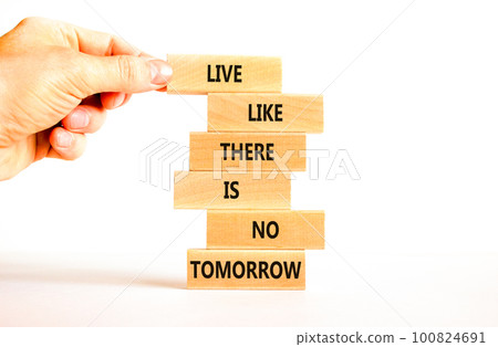 Live like no tomorrow symbol. Concept words Live like there is no tomorrow on wooden blocks. Beautiful white background. Businessman hand. Business Live like no tomorrow concept. Copy space. 100824691