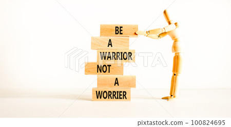 Warrior or worrier symbol. Concept words Be a warrior not a worrier on wooden blocks on a beautiful white table white background. Businessman icon. Business warrior or worrier concept. 100824695