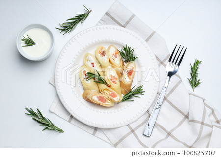 Concept of tasty food, thin pancakes with filling, top view 100825702