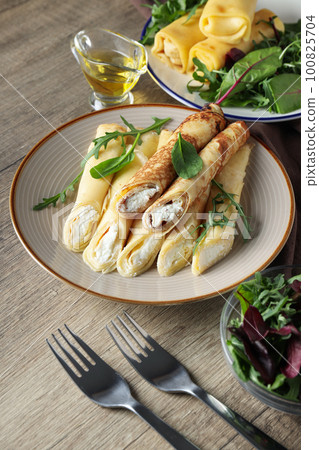 Concept of tasty food, thin pancakes with filling 100825704