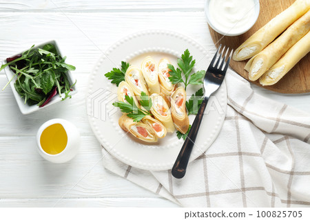 Concept of tasty food, thin pancakes with filling, top view 100825705